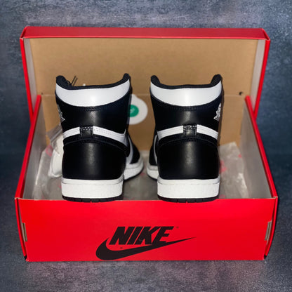 The heels of black and white Nike Air Jordan 1 Retro High 85 sneakers with a red and black Nike Air Jordan sneaker box.