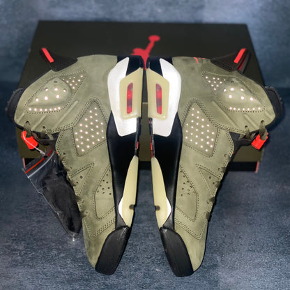 The medial side of the military green Air Jordan 6 Travis Scott sneakers with a green and black Air Jordan Travis Scott sneaker box.