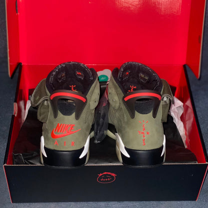 The heels of the military green Air Jordan 6 Travis Scott sneakers with a green and black Air Jordan Travis Scott sneaker box.