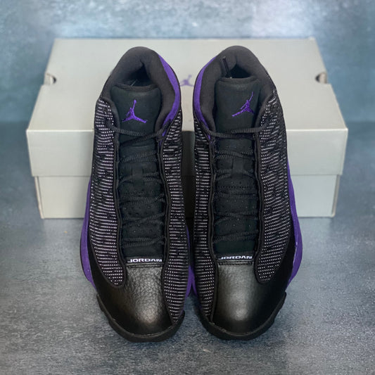 Purple and black Air Jordan 13 Retro sneakers with a light grey Air Jordan sneaker box.