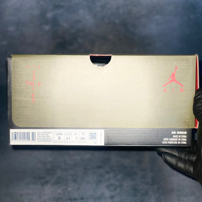 The green and black Air Jordan 6 Travis Scott sneaker box with the barcode, style code, size, and other sneaker information on a label.