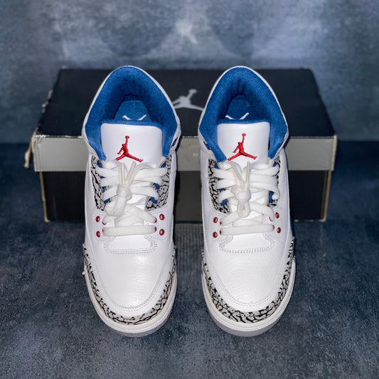 White and blue Air Jordan 3 Retro True Blue grade school sneakers with a black and grey Air Jordan sneaker box.